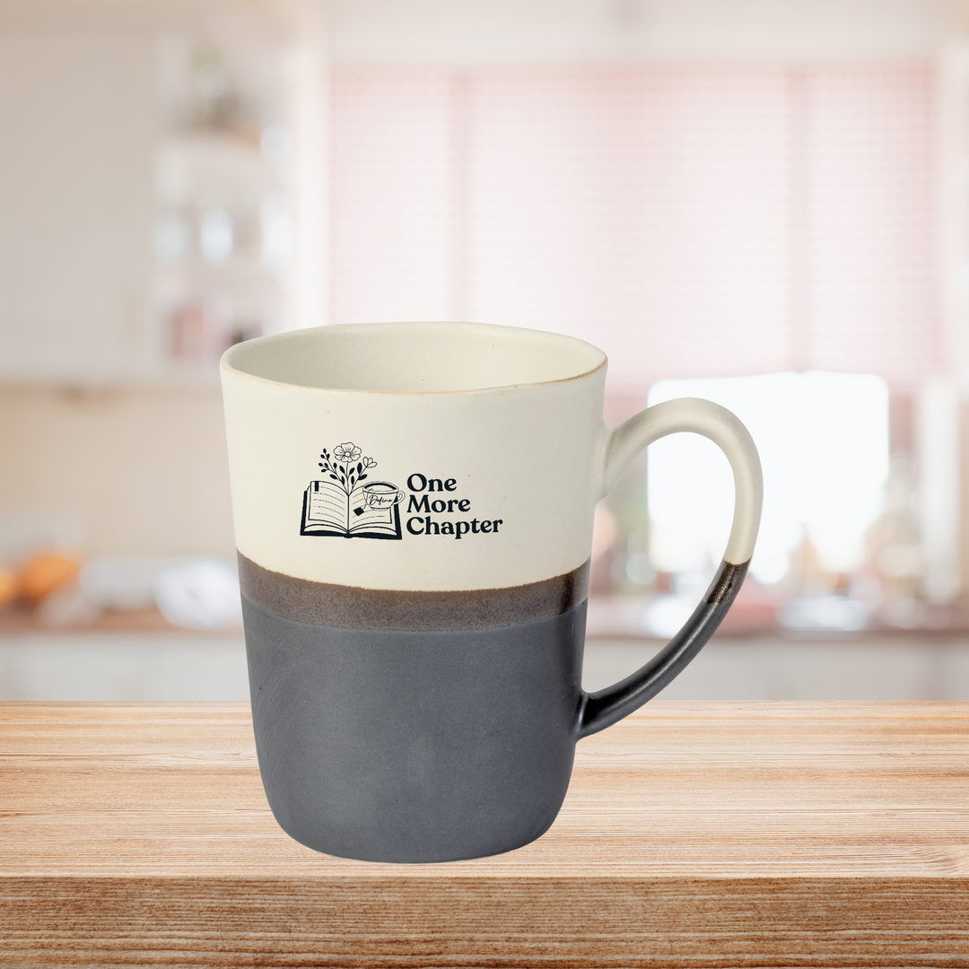 'One More Chapter' Porcelain Mug - 15 oz. displayed on kitchen counter, stylish drinkware for home and garden kitchen and dining decor.