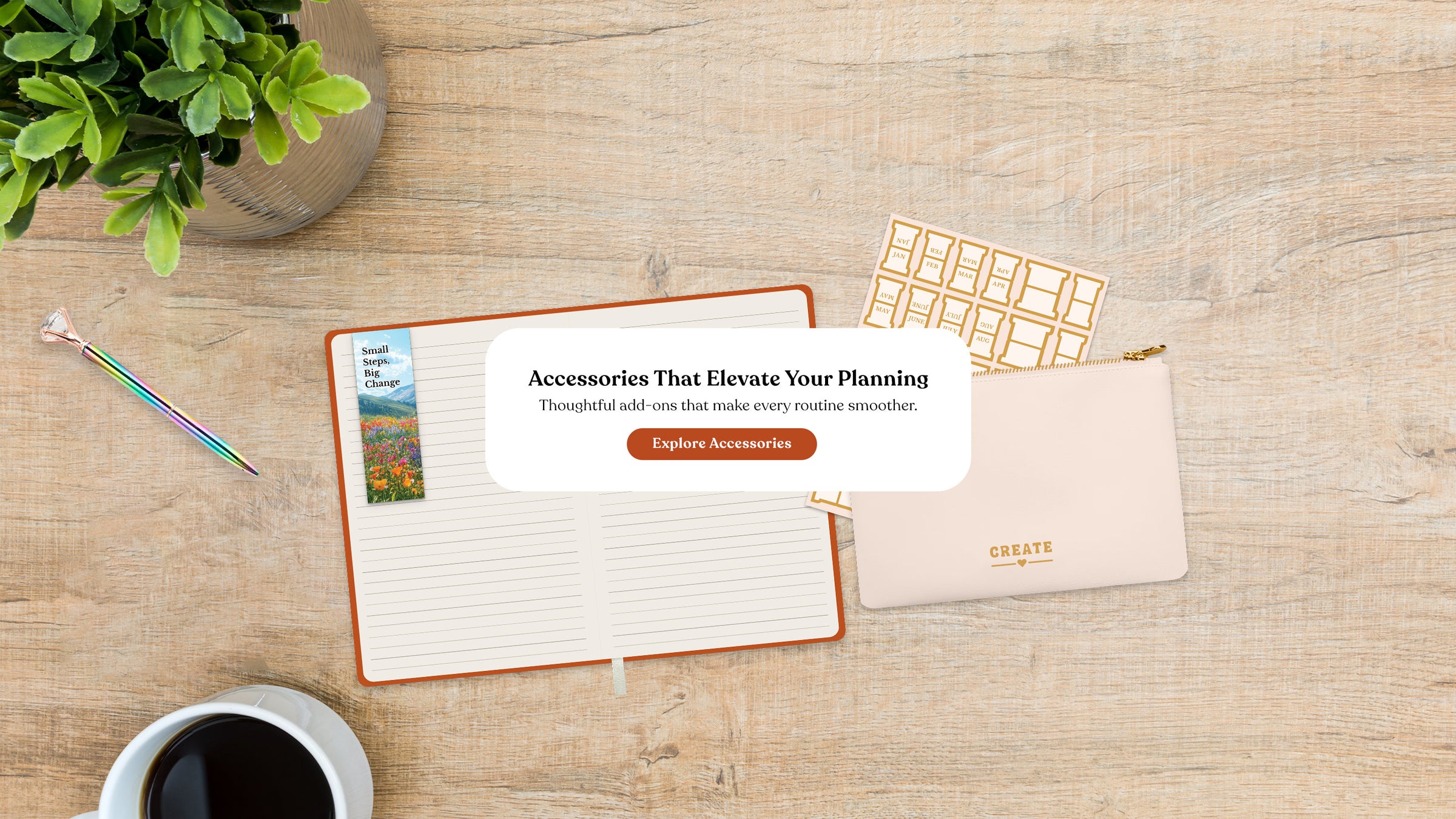 Desk setup with planner, pencil, coffee, and plant on a wooden surface