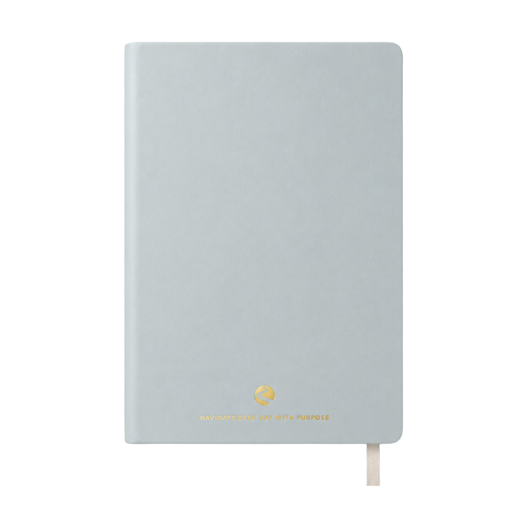 Light blue journal with a gold logo on a white background