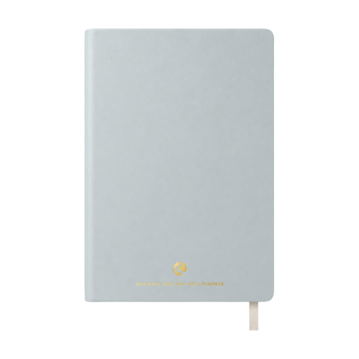Light blue journal with a gold logo on a white background