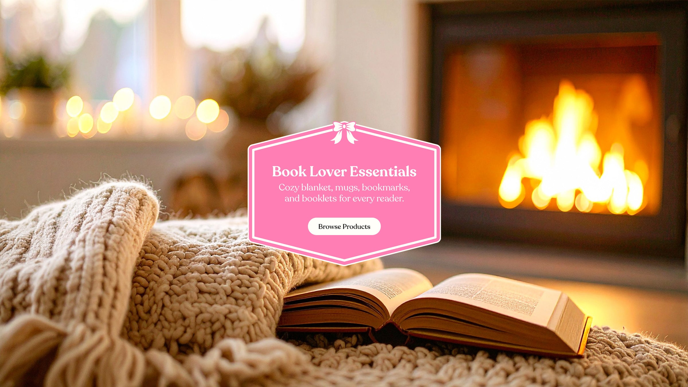 Open book on a blanket in front of a fireplace with 'Book Lover Essentials' text overlay.