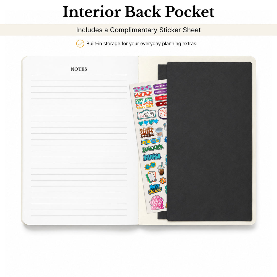 Planner with lined pages, a black cover, and a sheet of stickers on a white background 