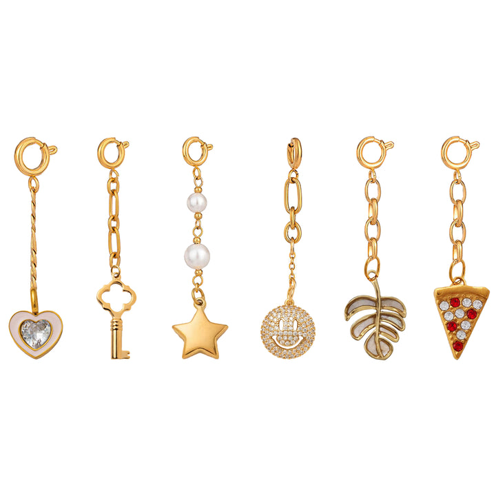 Set of gold charm pendants on a white background