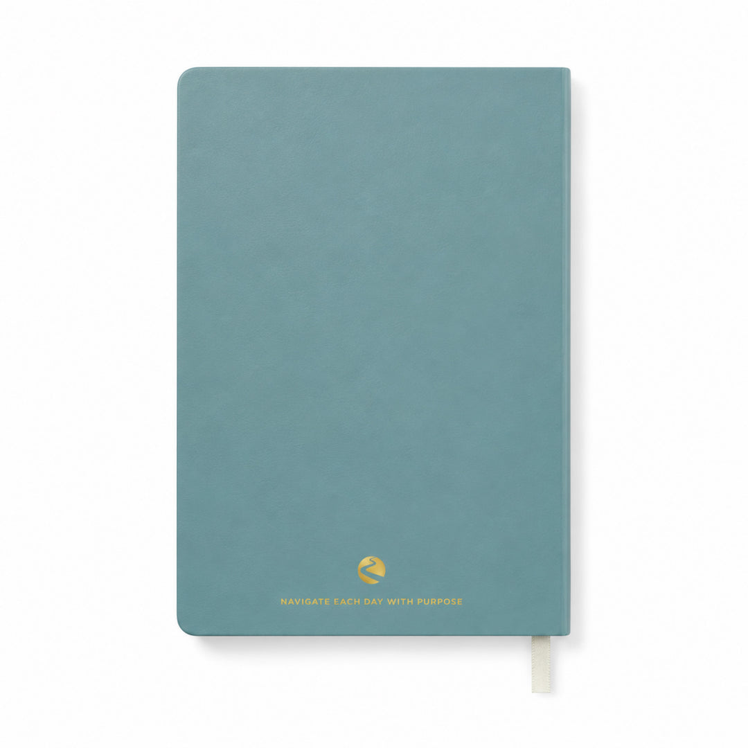 Blue journal with a gold quote on a white background  