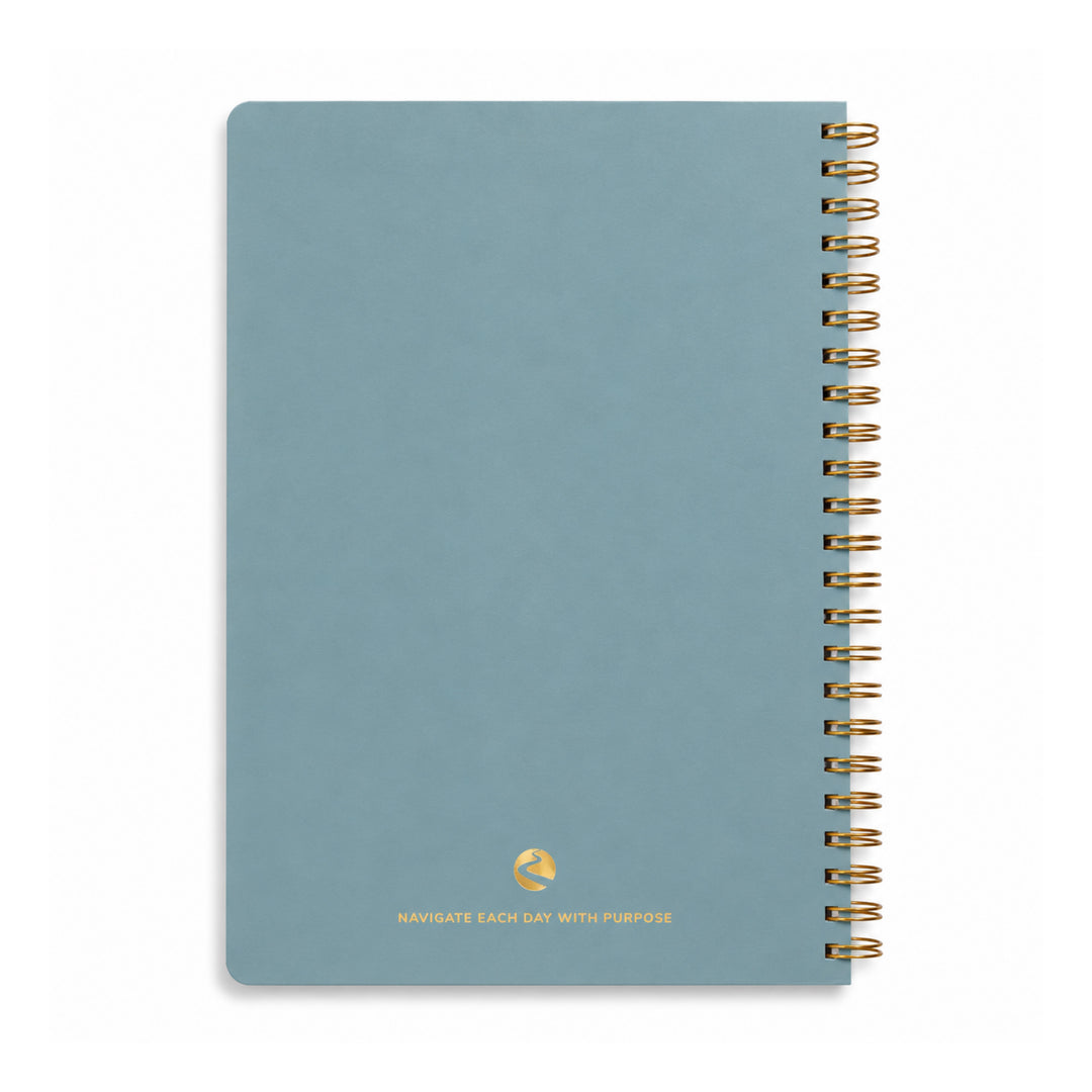 Blue notebook with gold spiral binding on a white background 