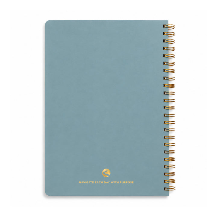 Blue notebook with gold spiral binding on a white background 