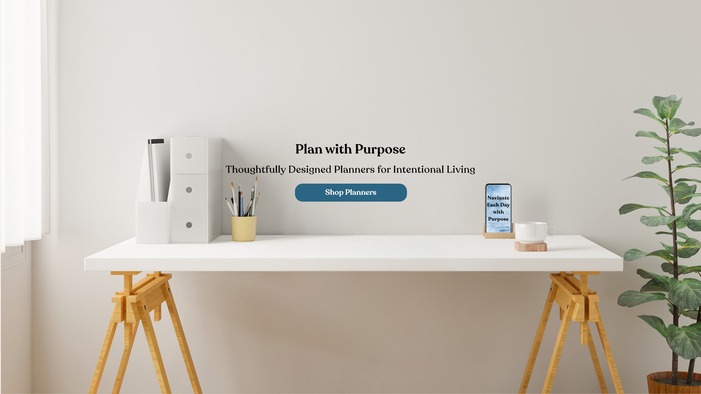 Modern desk setup with a plant and planner on a white wall background