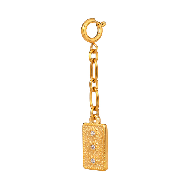 Gold charm with a rectangular tag and chain on a white background 