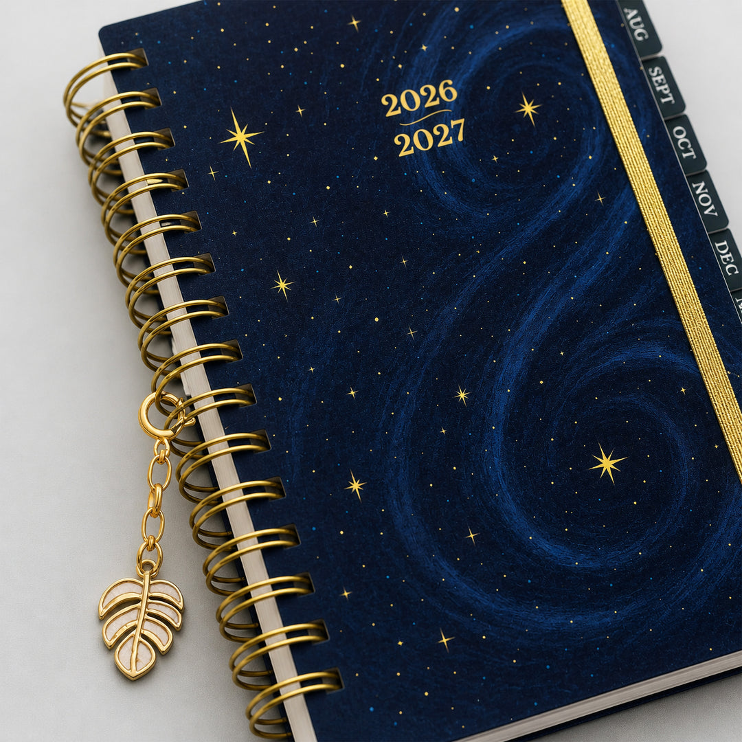2026-2027 planner with starry design and gold leaf charm on a white background 