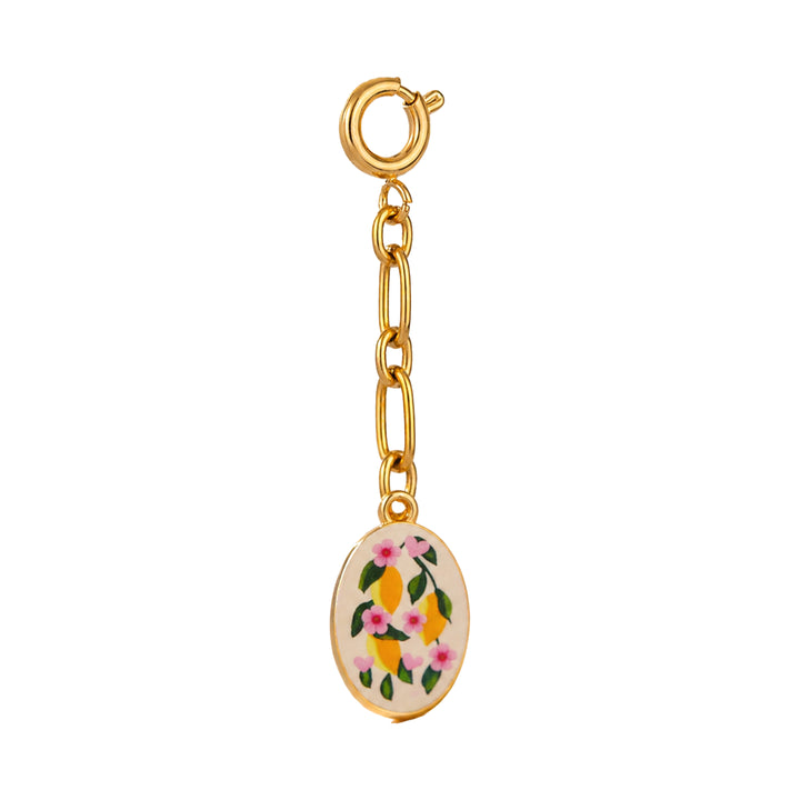 Gold charm with lemon and floral design on a white background 