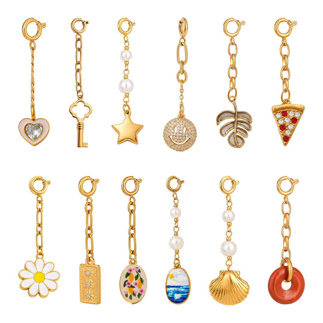 Collection of various gold charms on a white background 