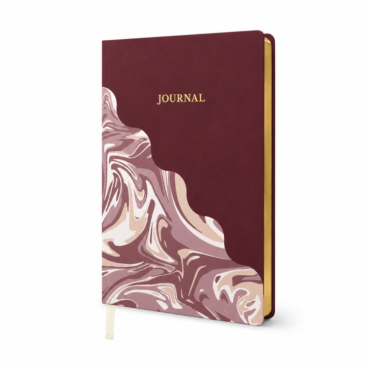Journal with maroon cover and marble pattern on a white background 