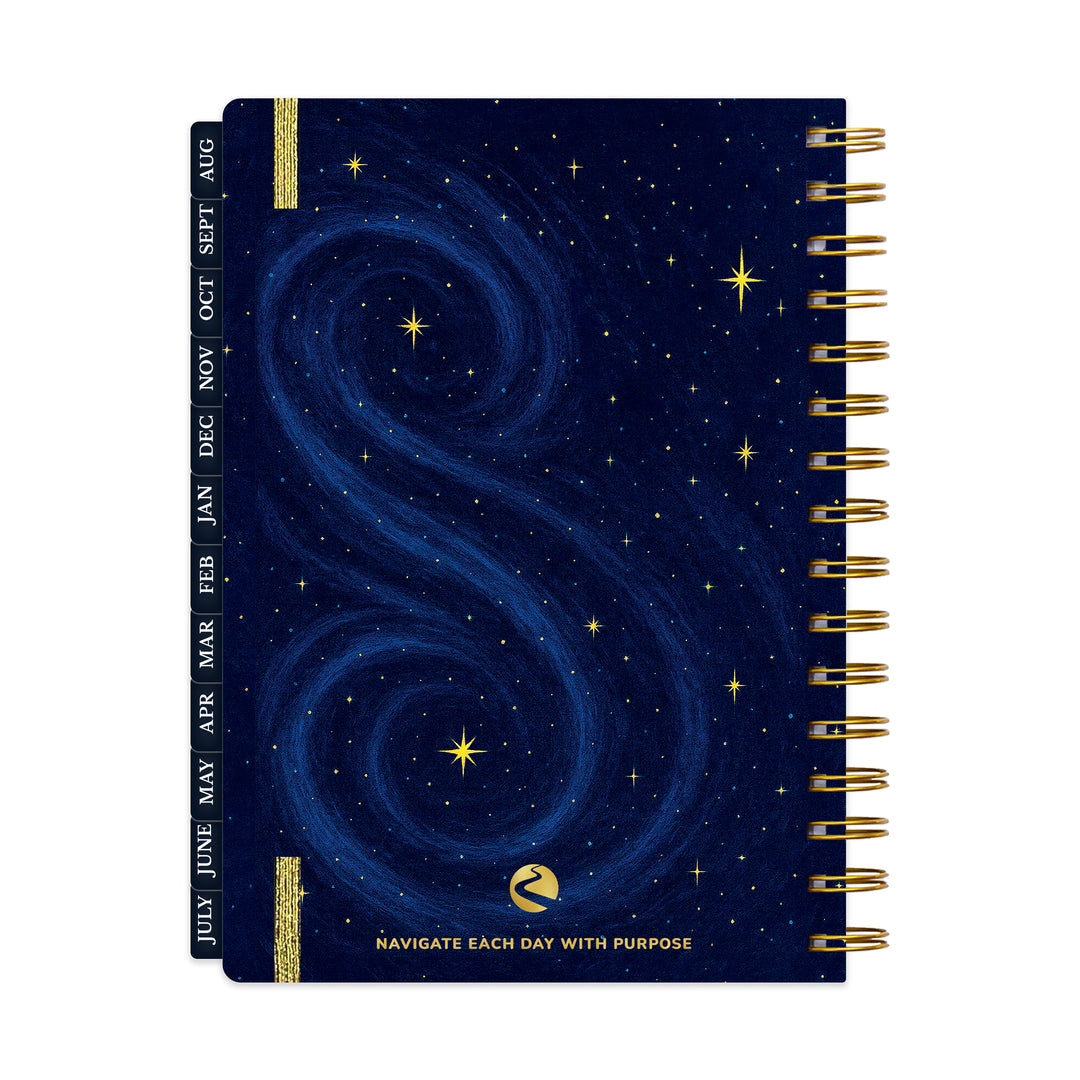 Spiral-bound planner with starry night design and gold accents on a white background 