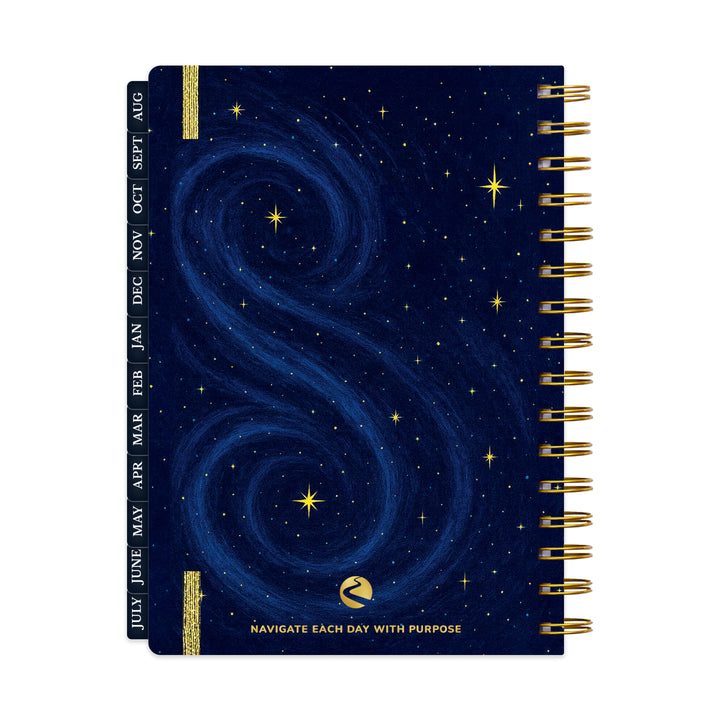 Spiral-bound planner with starry night design and gold accents on a white background 