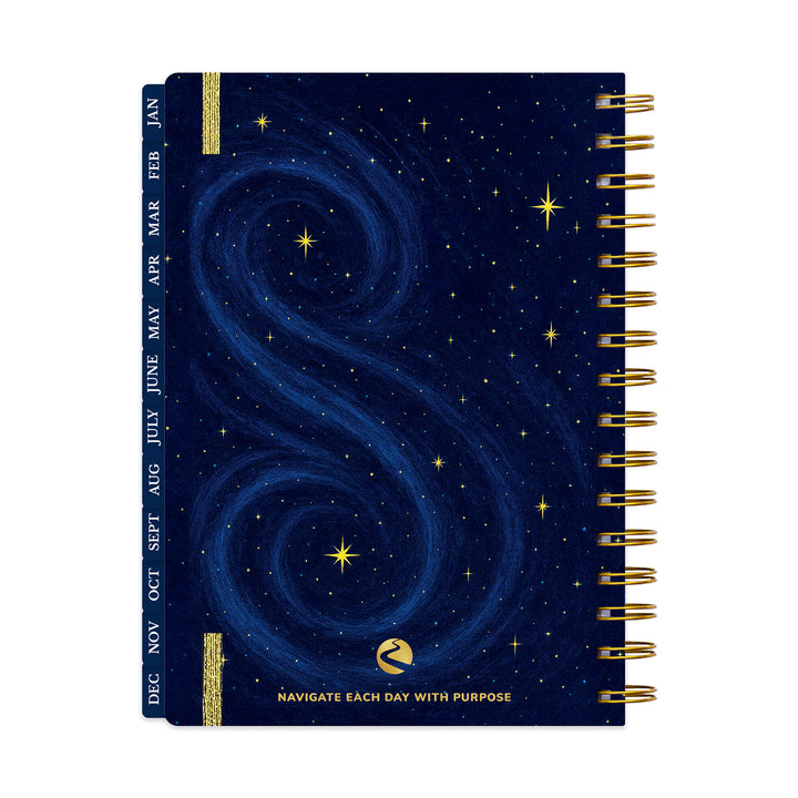 Spiral-bound planner with starry night design and gold accents on a white background 