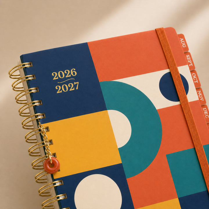 Colorful planner with geometric design and 2026-2027 text on a beige background 