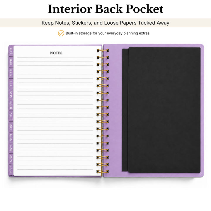 A spiral-bound planner or notebook shown open on a white background, with a lavender/light purple cover and a black interior pocket. Text above reads &