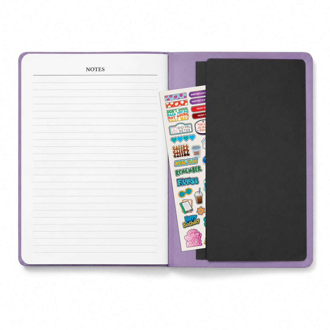 Purple notebook with a sticker sheet and black cover on a white background 