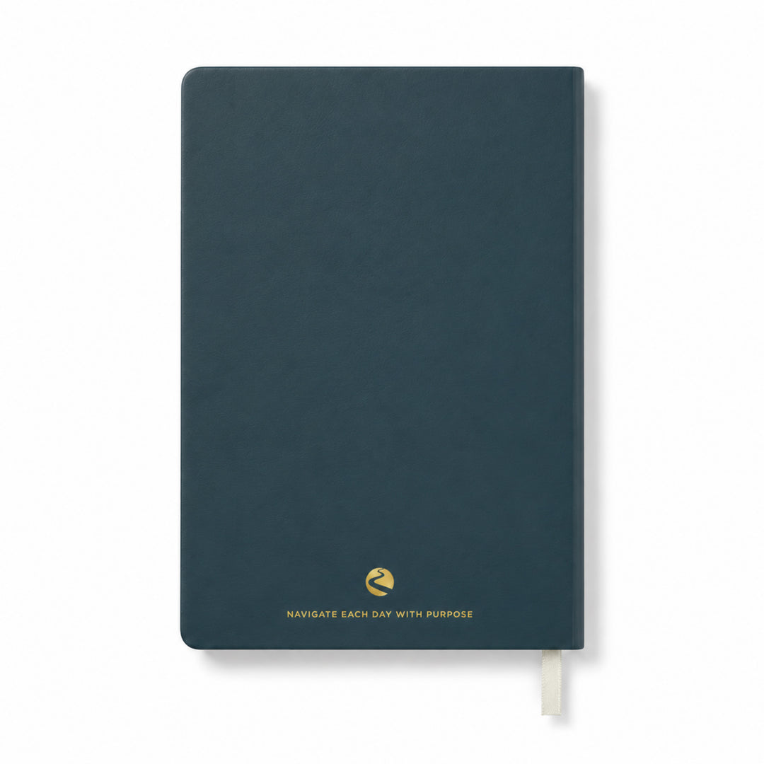 Dark blue journal with a gold quote on a white background 