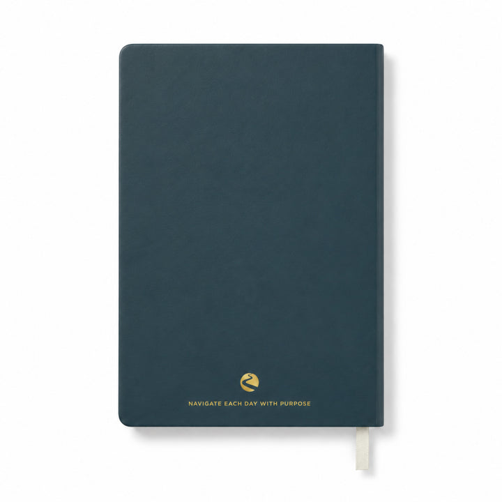 Dark blue journal with a gold quote on a white background 