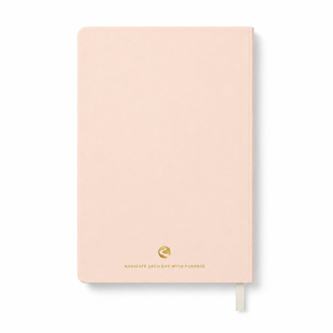 Pink journal with a gold logo and text on a white background 