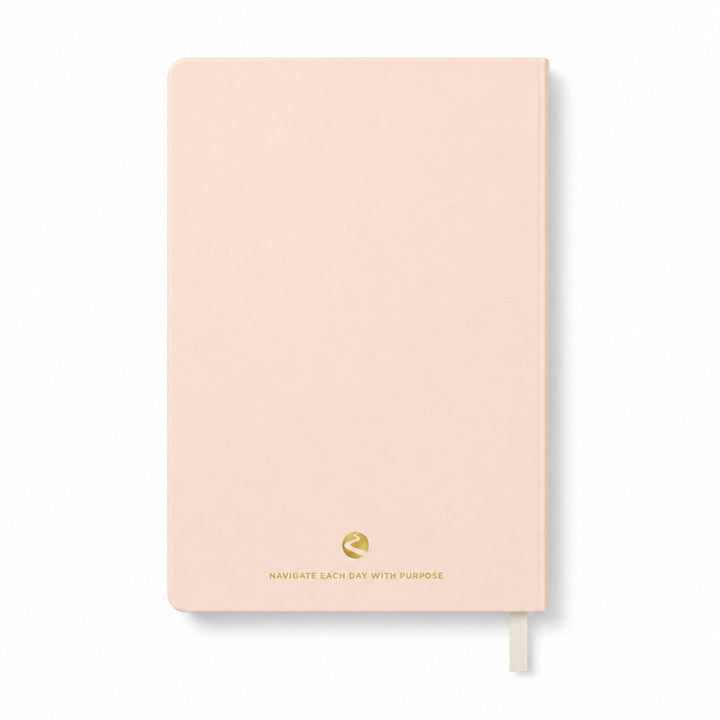 Pink journal with a gold logo and text on a white background 