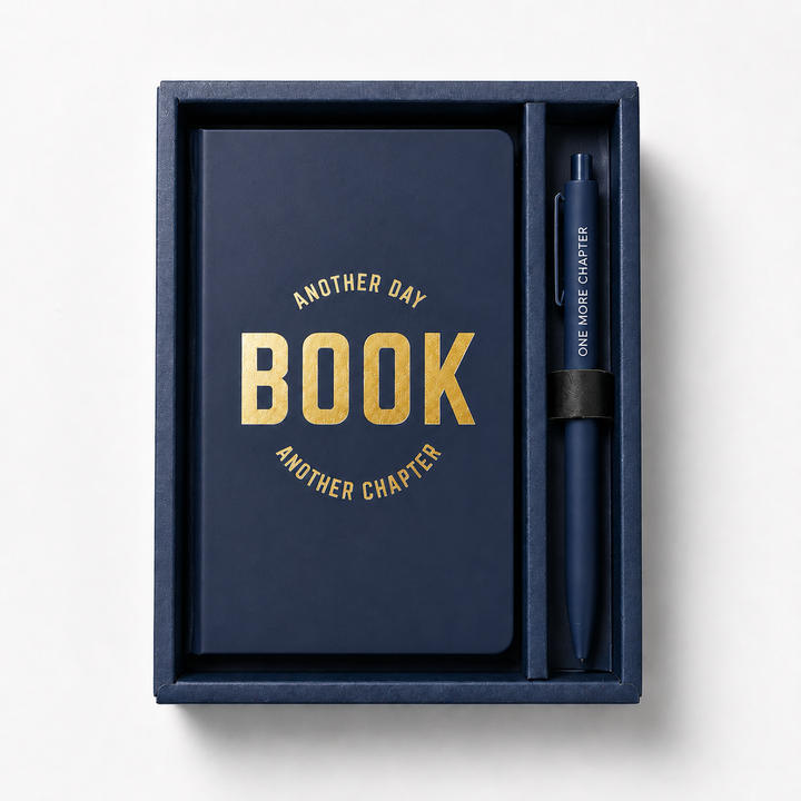 Blue notebook with yellow text and a matching pen in a box on a white background 