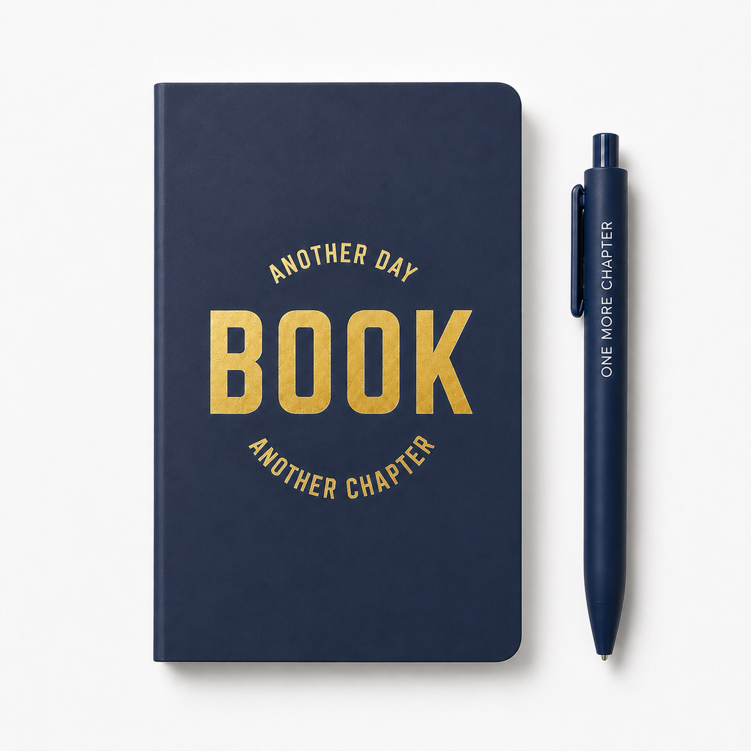 A navy blue hardcover notebook with gold foil text reading &