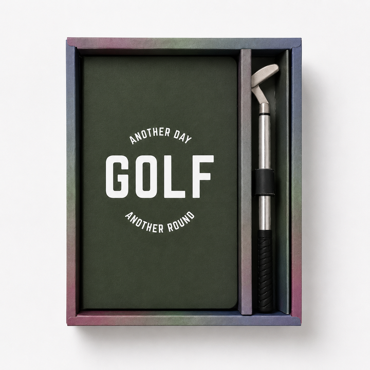 Golf-themed stationery set with a green notebook and pen in a colorful box. 