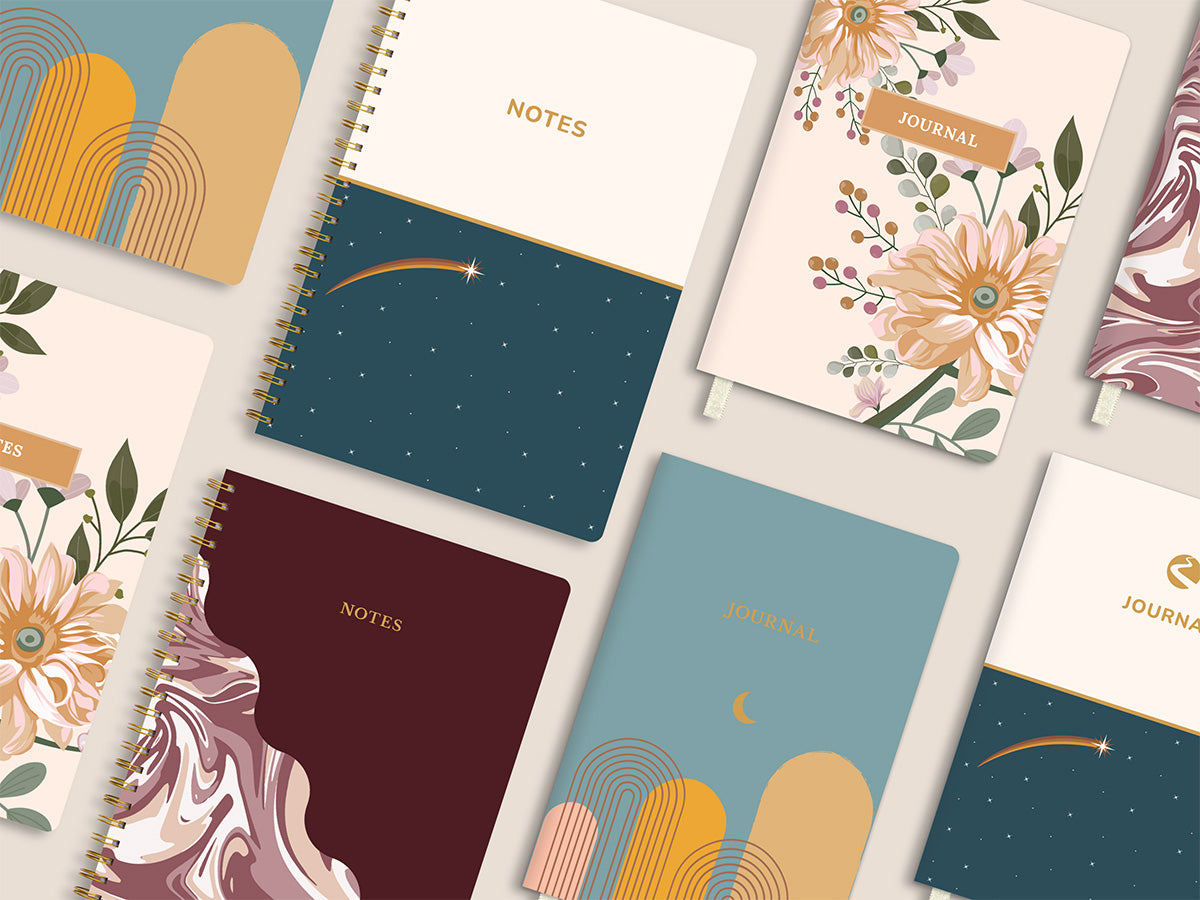 Picture of Define's Matching Notebooks and Journals. Includes the following gold-spiral notebooks and Softcover Journals: Marble Burgundy, Tranquil Garden, Starry Sky, and Desert Moon. 