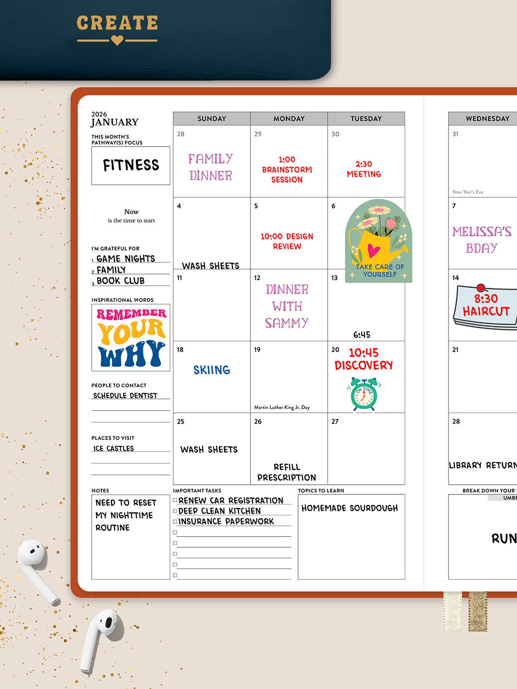Define's monthly calendar spread decorated with stickers and plans on a tan background