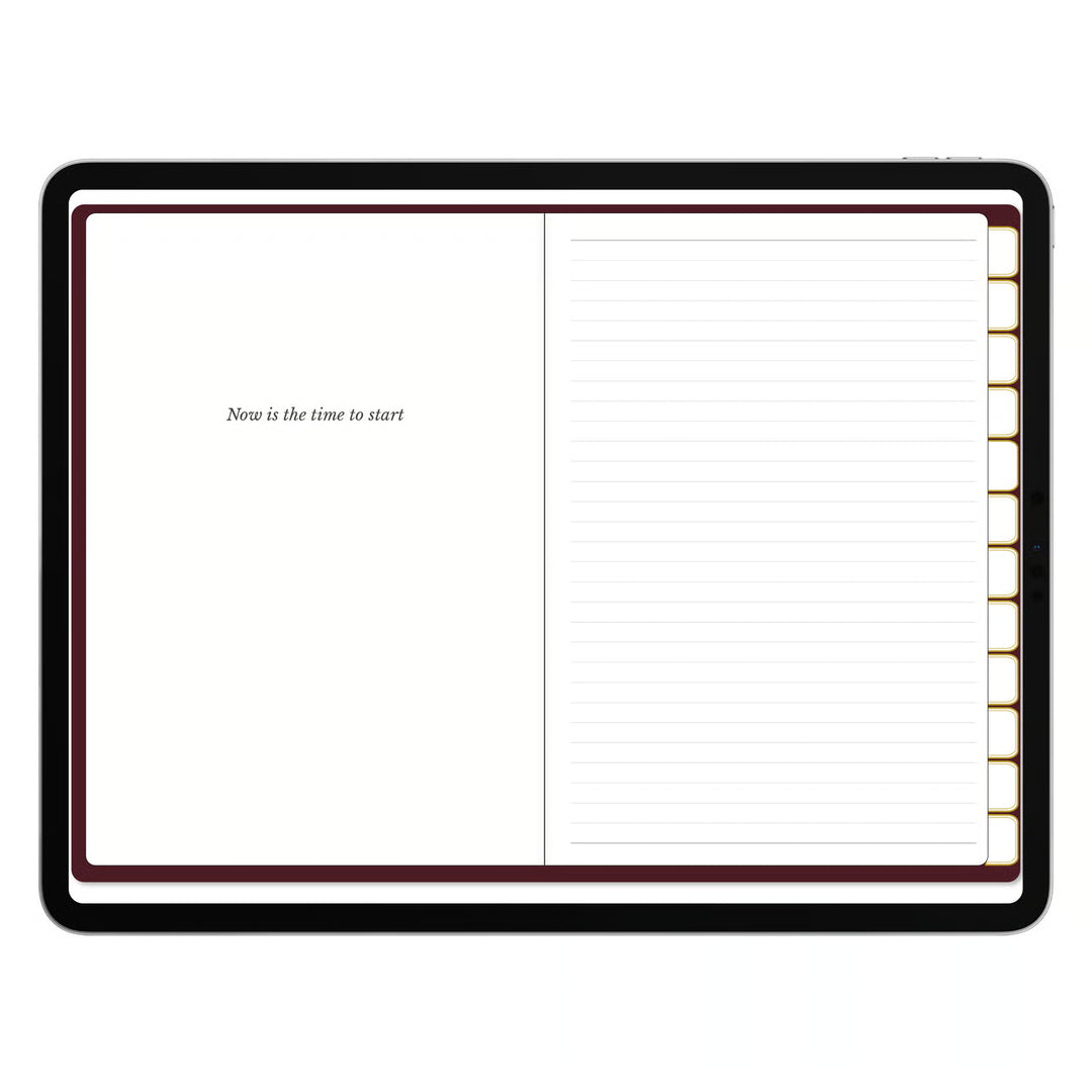 An open planner or notebook with a black cover, featuring a blank left page with the text &