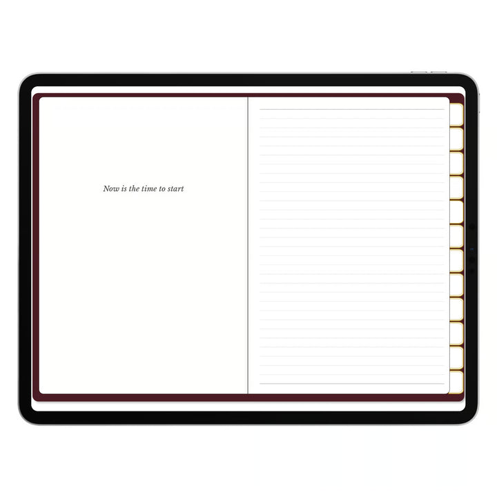 An open planner or notebook with a black cover, featuring a blank left page with the text &