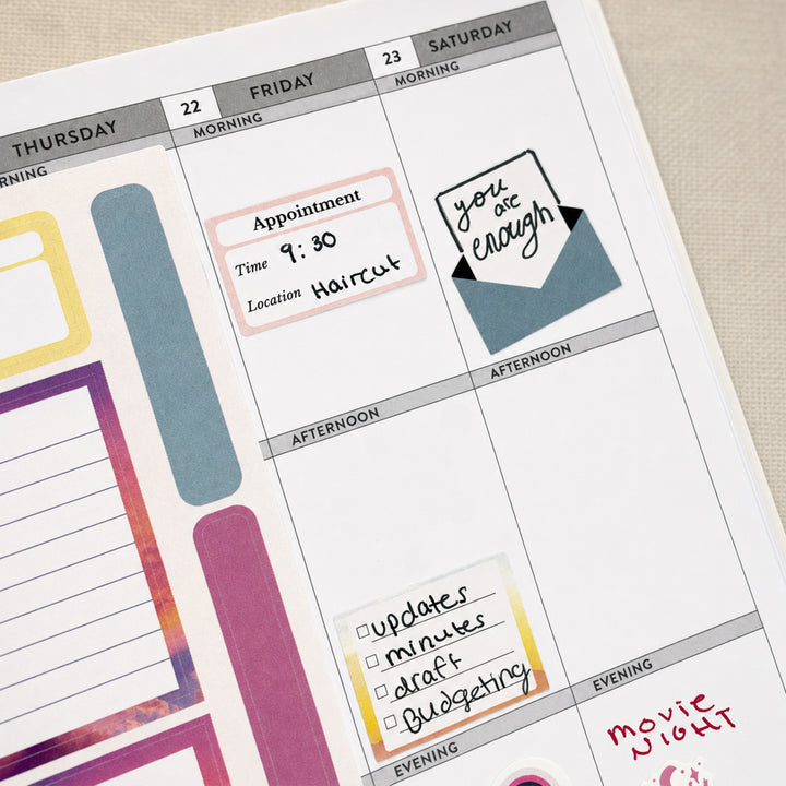 Close-up of monthly tab stickers from Purposeful Planning Stickers for Journals &amp; Planners applied to a calendar for streamlined monthly planning