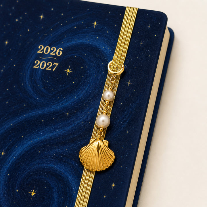 Blue planner with a decorative gold strap featuring pearls and year markers on a white background 