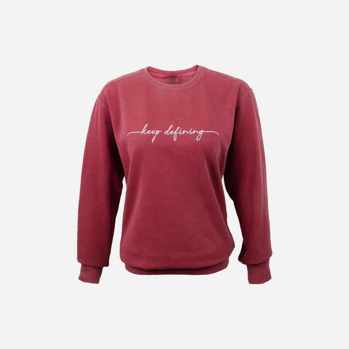 Front of the rouge comfort colors crewneck sweatshirt with "keep defining" embroidered across the chest. #color_rouge